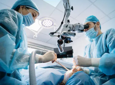 patient in dental chair with staff around them