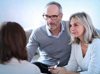 older couple talking with a doctor