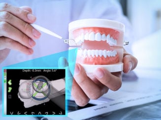 person holding a set of model teeth
