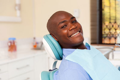 smiling ma in dental chair